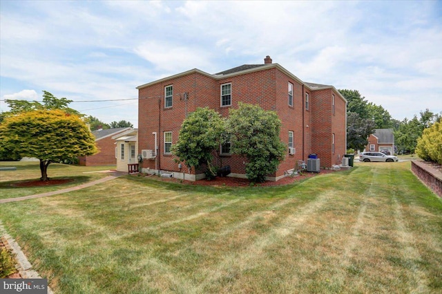 view of side of home featuring a yard and cooling unit