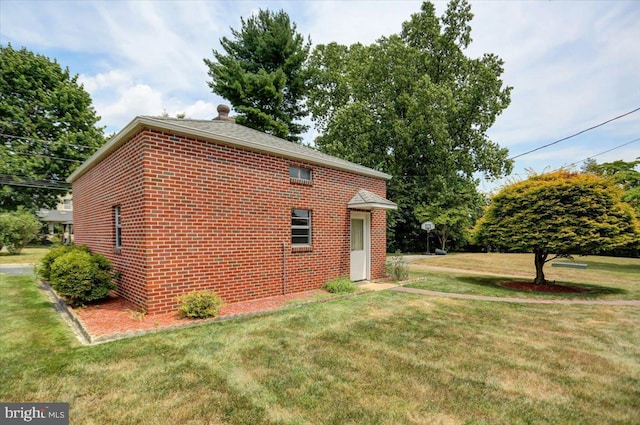 view of side of property with a lawn