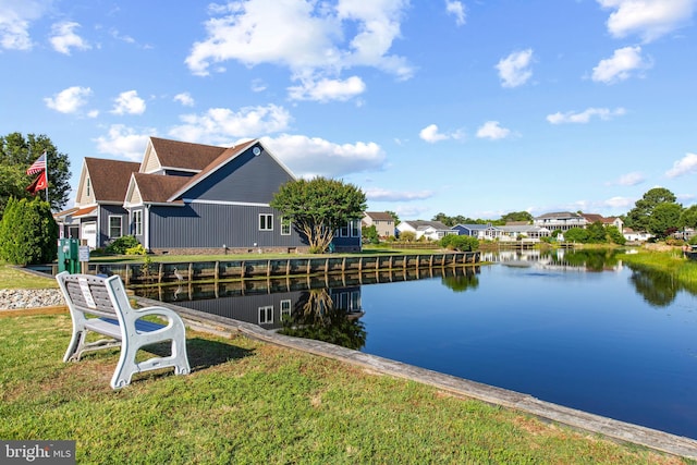 dock area featuring a lawn and a water view