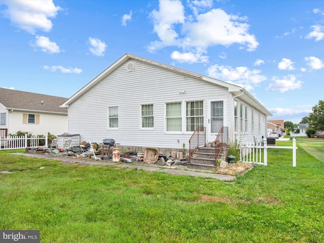 back of house with a yard