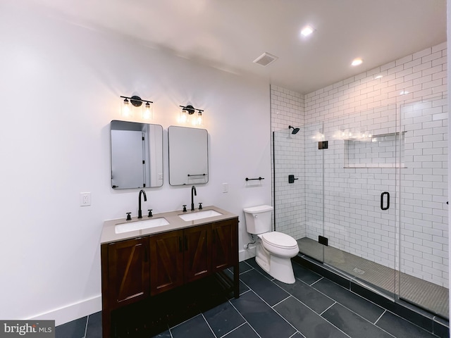 bathroom featuring tile patterned flooring, vanity, a shower with shower door, and toilet