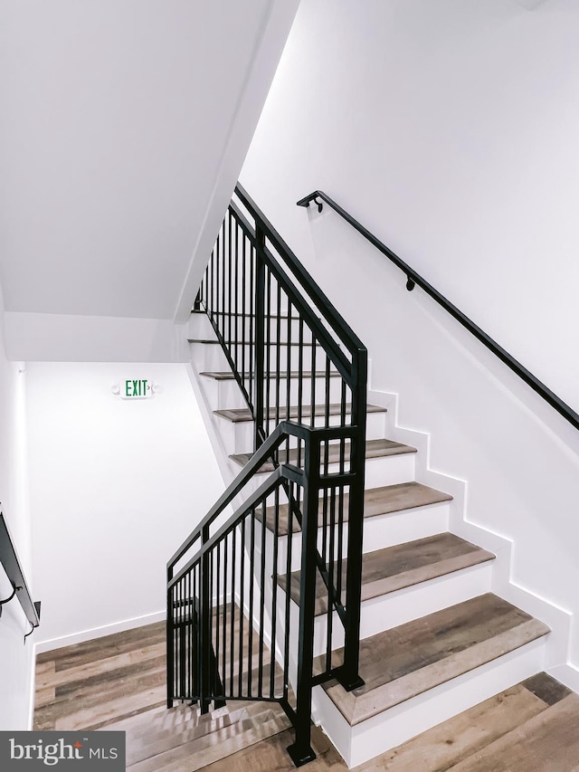 stairs featuring hardwood / wood-style flooring