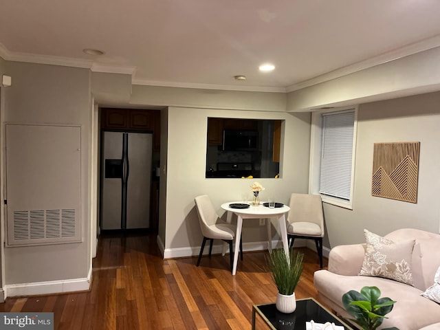 living room featuring crown molding and dark hardwood / wood-style flooring