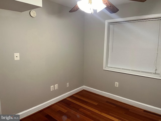 empty room featuring ceiling fan and dark hardwood / wood-style flooring