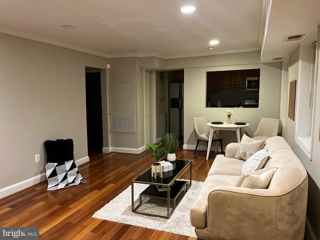 living room with crown molding and dark hardwood / wood-style floors