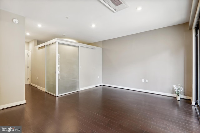 empty room featuring dark hardwood / wood-style flooring