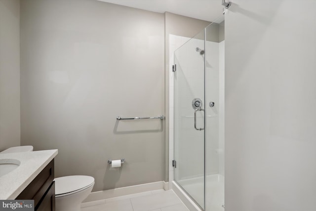 bathroom with tile patterned floors, toilet, vanity, and walk in shower