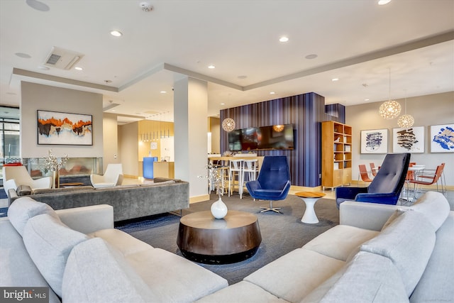 living room featuring a raised ceiling and carpet floors