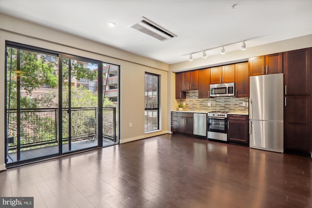 kitchen with tasteful backsplash, dark wood-type flooring, and appliances with stainless steel finishes