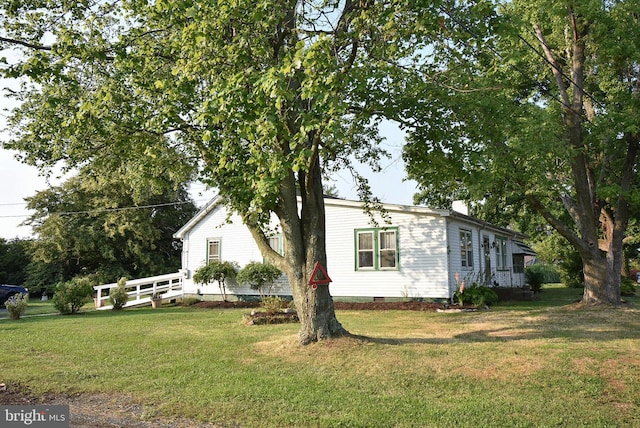 view of side of home with a lawn