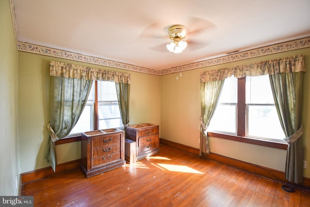 unfurnished room with hardwood / wood-style flooring and ceiling fan