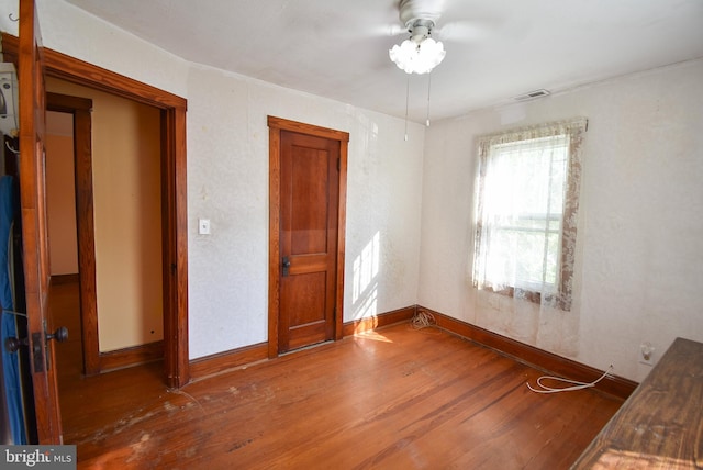 empty room with wood-type flooring and ceiling fan