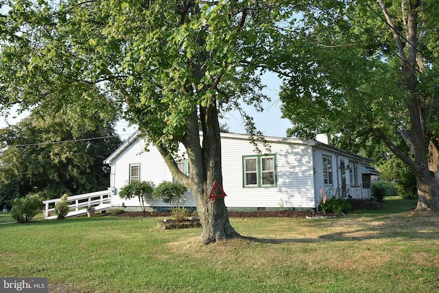 view of side of home featuring a lawn