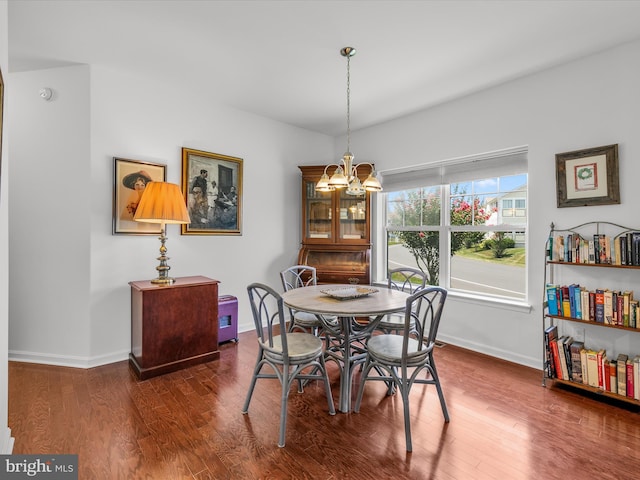 dining space with a chandelier and dark wood-type flooring