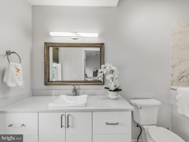 bathroom featuring vanity and toilet