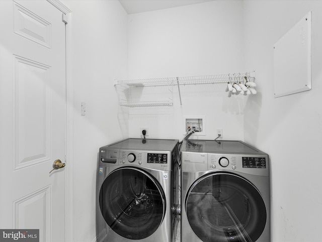 clothes washing area featuring separate washer and dryer