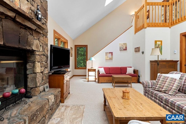 living room featuring light carpet, high vaulted ceiling, and a stone fireplace