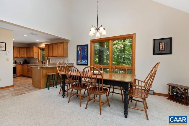 carpeted dining room with a towering ceiling and a notable chandelier