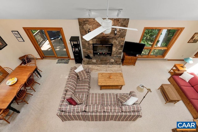 living room with carpet floors, a fireplace, and rail lighting