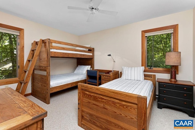 carpeted bedroom with ceiling fan and multiple windows