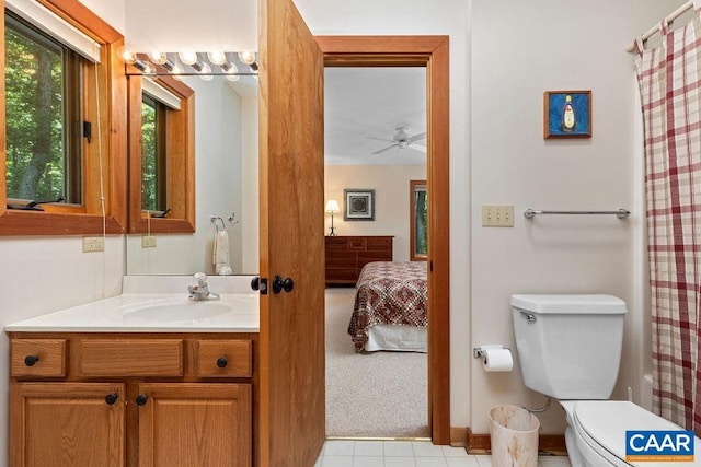 bathroom with a shower with curtain, vanity, ceiling fan, tile patterned flooring, and toilet