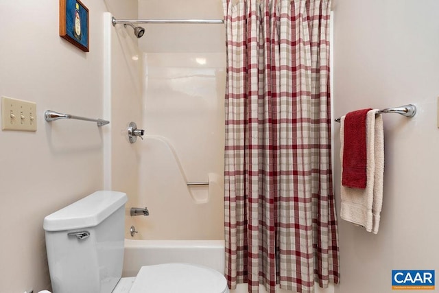 bathroom featuring shower / tub combo and toilet