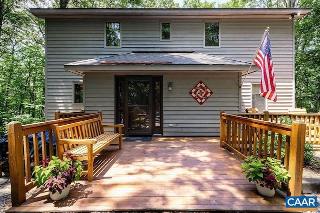 rear view of house featuring a deck