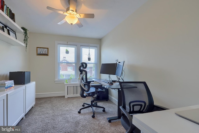 carpeted office with radiator and ceiling fan