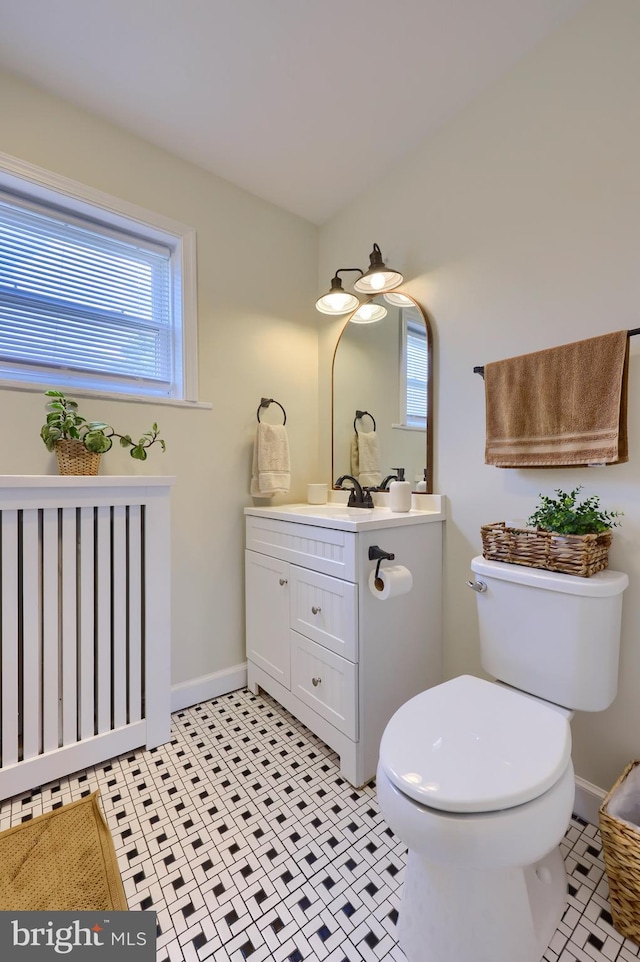 bathroom with tile patterned floors, vanity, and toilet