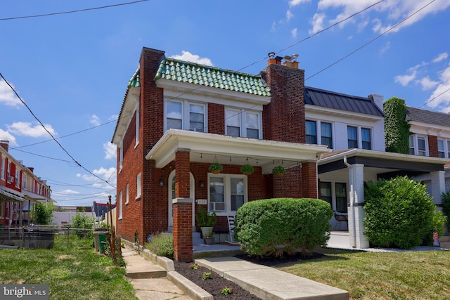 view of front facade with covered porch and a front yard