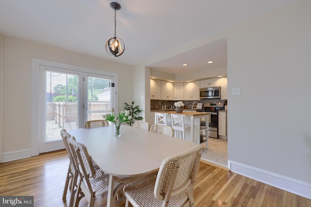 dining space with light hardwood / wood-style flooring