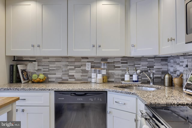 kitchen with decorative backsplash, sink, white cabinetry, and black dishwasher