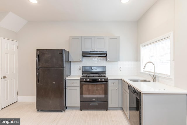 kitchen with gray cabinetry, light tile patterned floors, black appliances, and sink