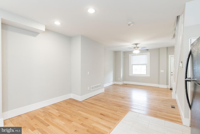 unfurnished living room with ceiling fan and light hardwood / wood-style flooring