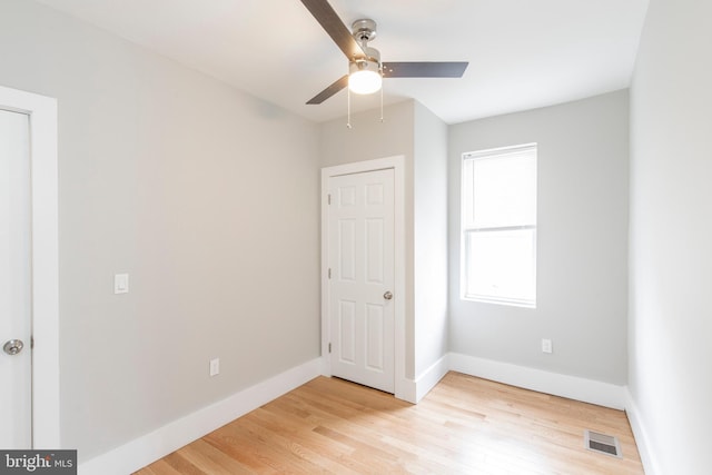 unfurnished bedroom with ceiling fan and light hardwood / wood-style flooring