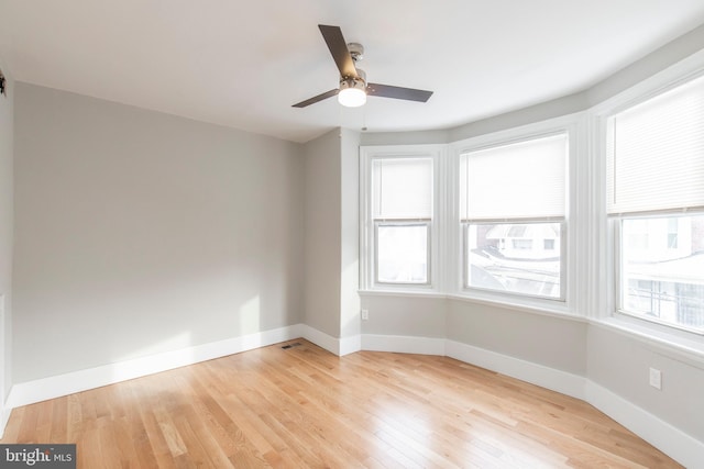 spare room featuring ceiling fan and light wood-type flooring