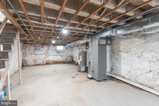 basement featuring electric water heater and electric panel