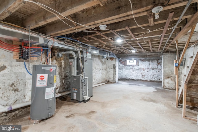 basement featuring heating unit and electric water heater