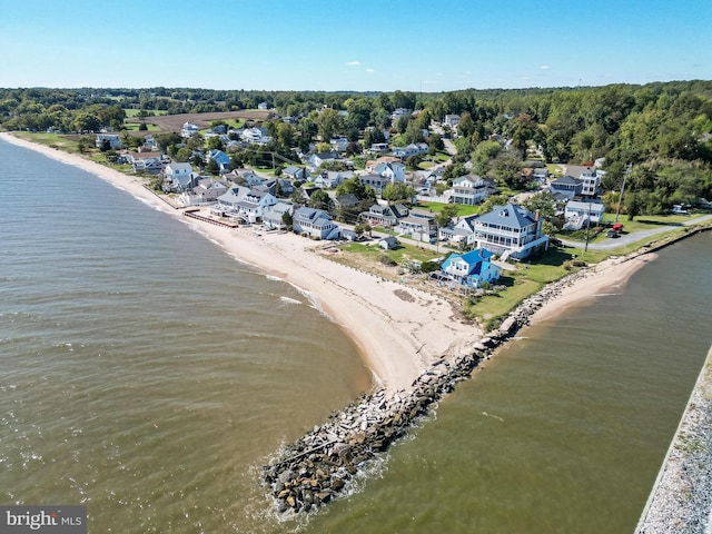 bird's eye view featuring a water view and a beach view