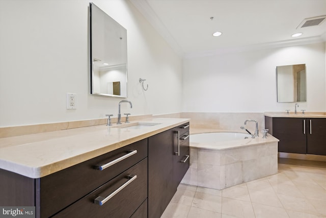 bathroom featuring tile patterned flooring, vanity, crown molding, and tiled tub