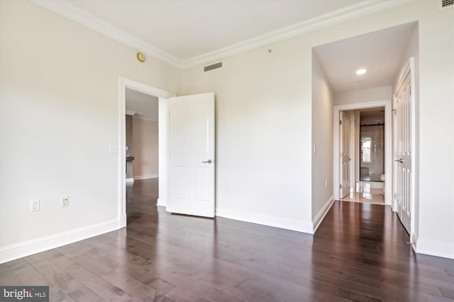 unfurnished room with dark hardwood / wood-style floors and crown molding