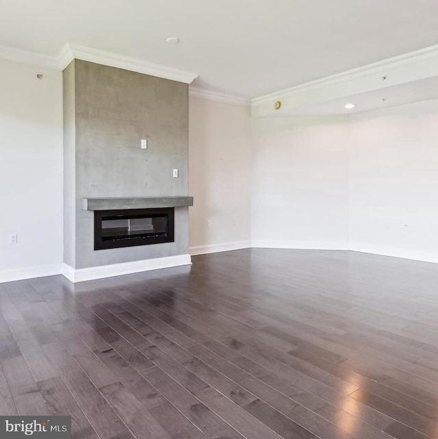 unfurnished living room featuring ornamental molding and dark wood-type flooring