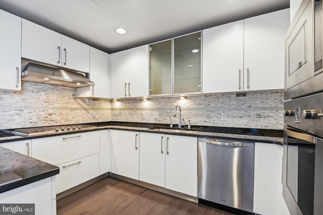 kitchen with white cabinets, decorative backsplash, sink, and appliances with stainless steel finishes