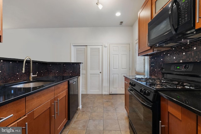 kitchen with black appliances, sink, dark stone countertops, light tile patterned floors, and tasteful backsplash