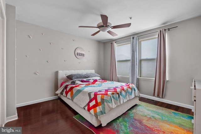 bedroom with ceiling fan and dark hardwood / wood-style floors