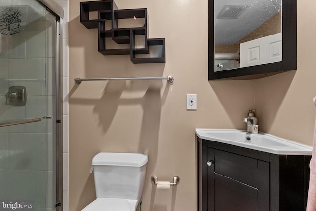 bathroom featuring vanity, toilet, and walk in shower