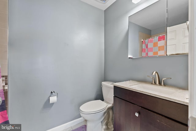 bathroom featuring vanity, curtained shower, and toilet