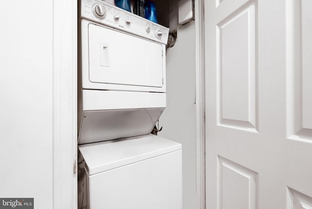 clothes washing area featuring stacked washer / dryer