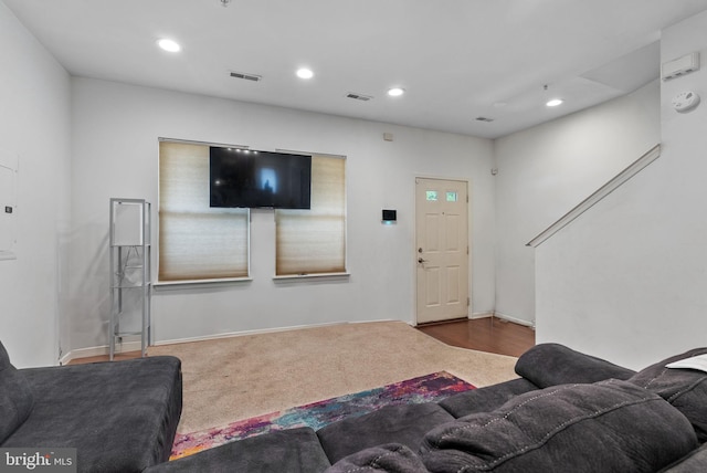 living room featuring dark colored carpet