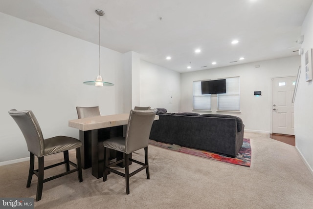 dining room featuring light colored carpet